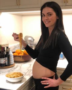 Ryan's wife posing with a baby bump