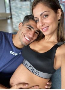 Hiba Abouk showing her pregnant stomach wit her husband Achraf Hakimi