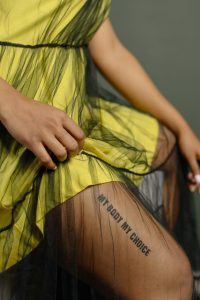 woman thigh with tattoo