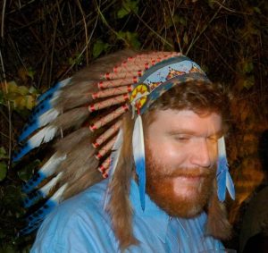 caucasian man wearing native american headress