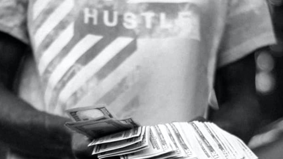 man counting money with hustle tshirt