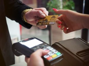 giving credit card to swipe on machine