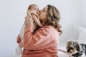 woman kissing her baby
