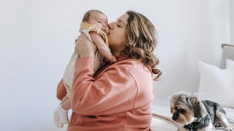 woman kissing her baby