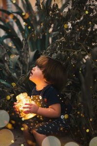 a child looking at fireflies